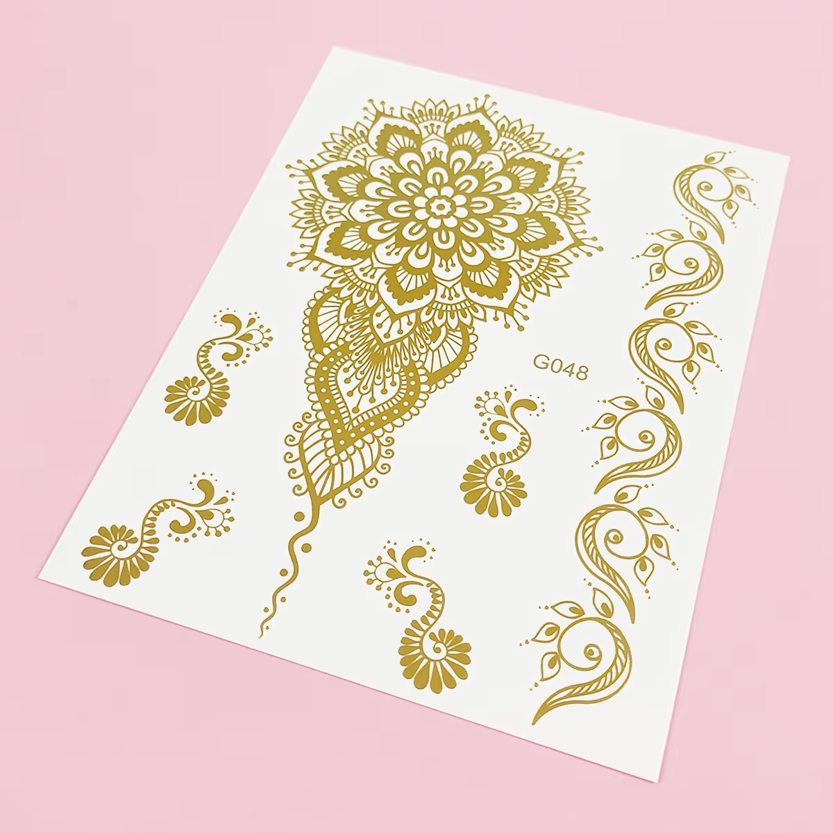 Gold mehndi floral sheet with mandala petals, paisley curves, and bracelet-like accents.