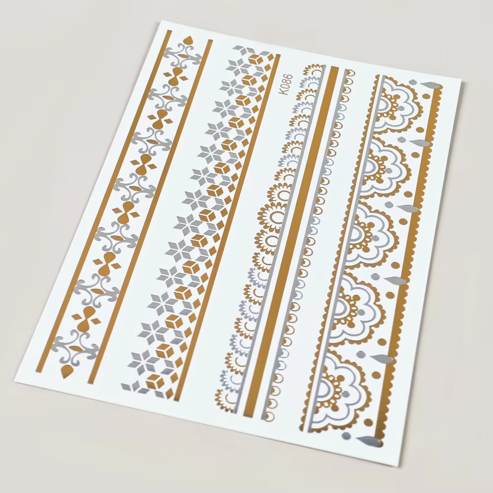 Gold-and-silver ornamental band sheet with floral lace borders and fine line details.