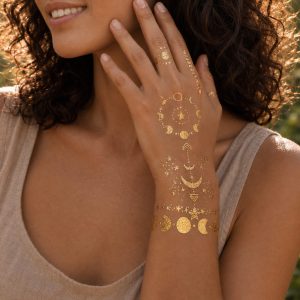 Gold moon and star temporary tattoo styled on the chest and shoulder