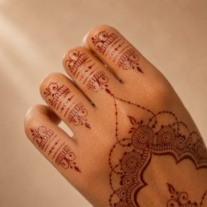 Close-up of brown mehndi lace temporary tattoo detail on the hand