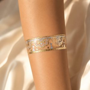 Metallic ornamental band temporary tattoo worn around the wrist
