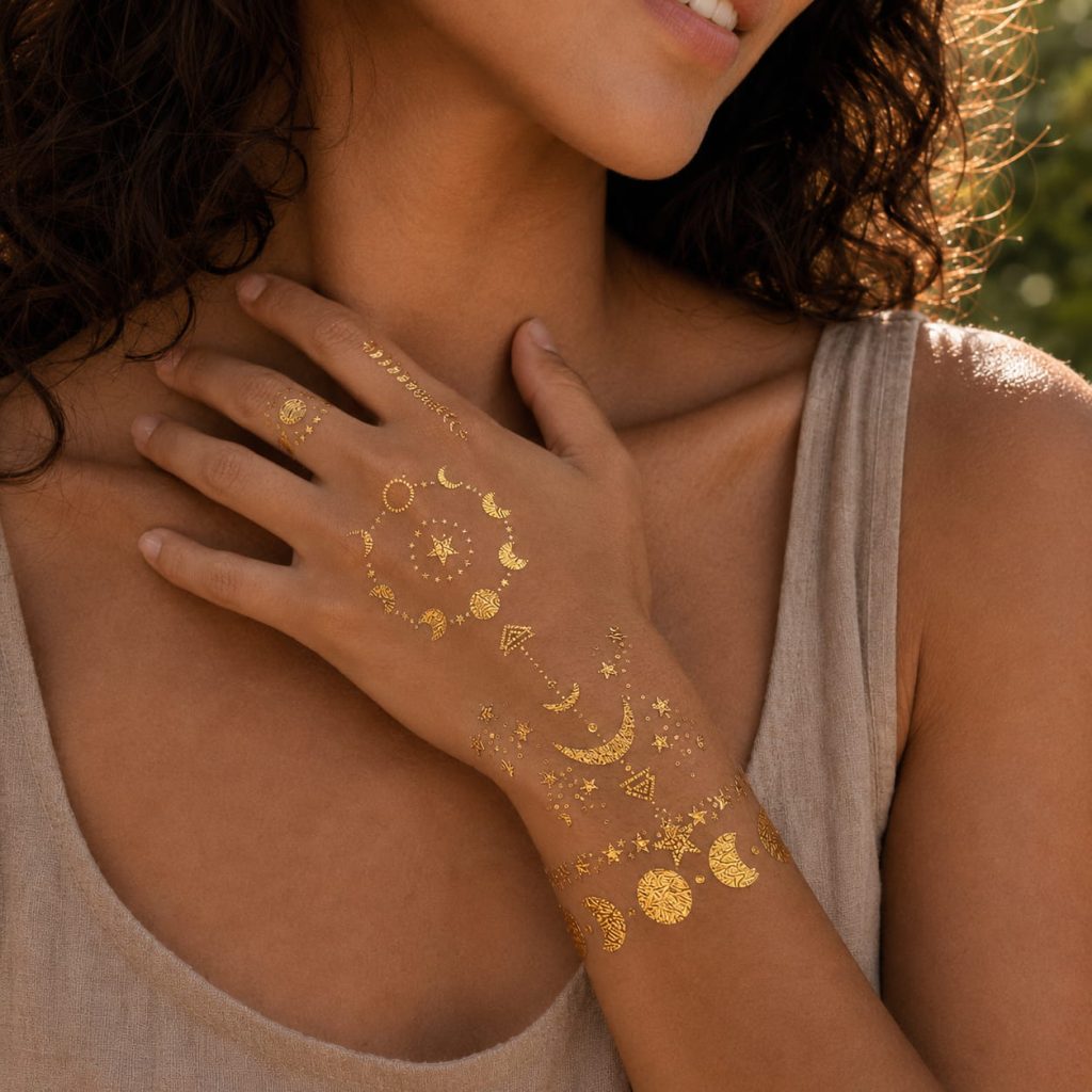Gold moon and star temporary tattoo worn near the collarbone