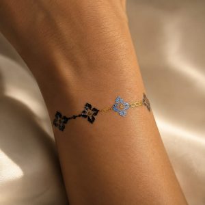 Metallic charm band temporary tattoo detail shown on the wrist