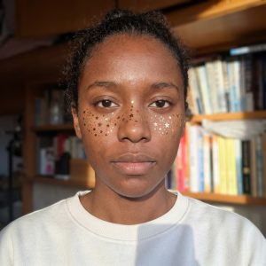 Tiny metallic star face temporary tattoos shown on the face