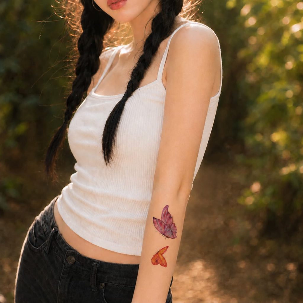 Watercolor butterfly temporary tattoos worn on the forearm