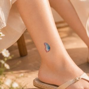 Watercolor butterfly temporary tattoo worn near the ankle
