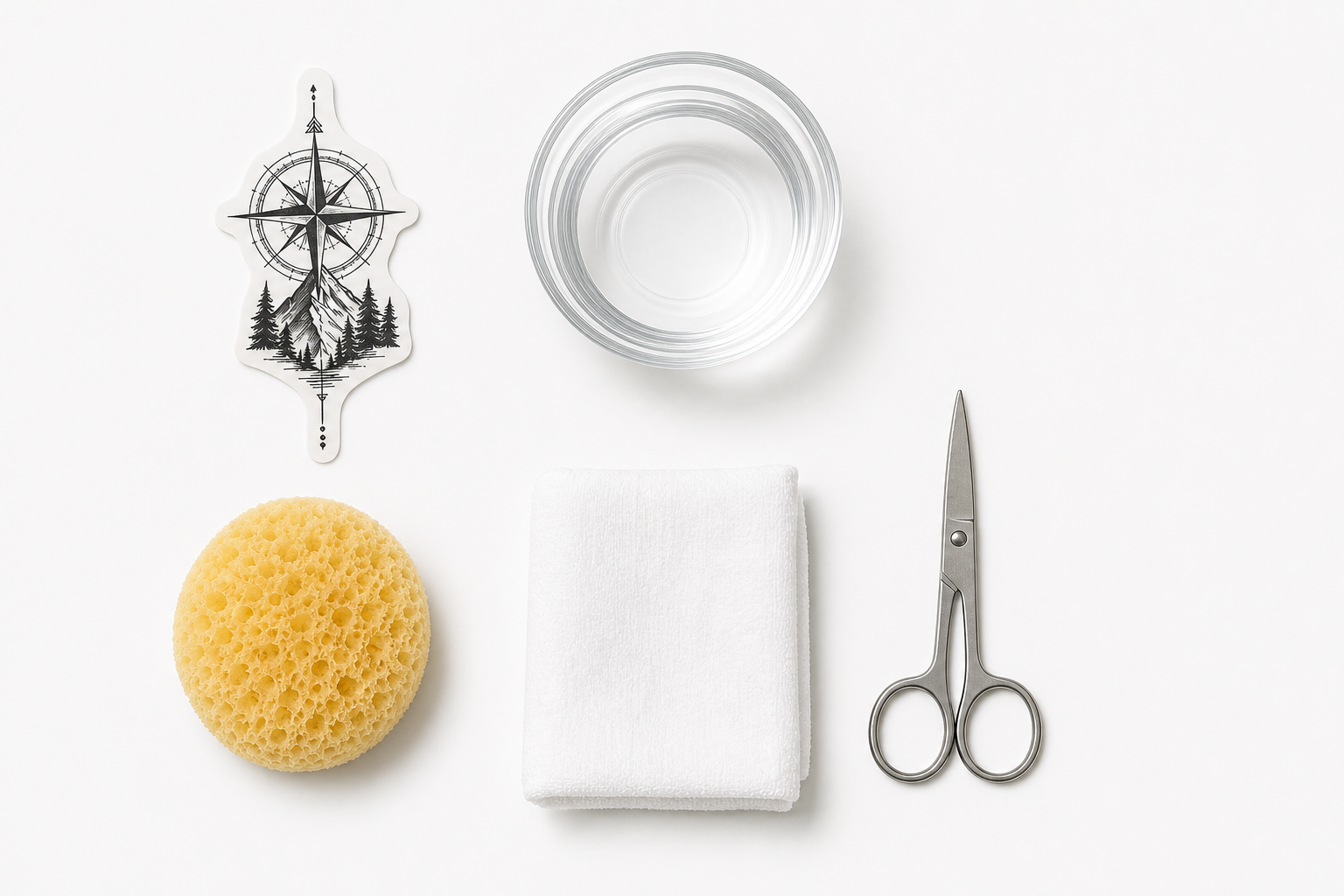 Temporary tattoo application supplies laid out on a clean white surface