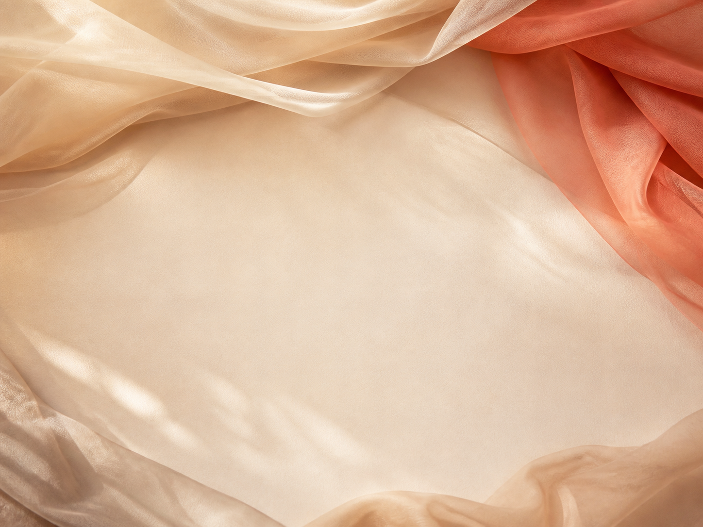 Cream and coral sheer fabrics arranged in soft folds for festival outfit planning