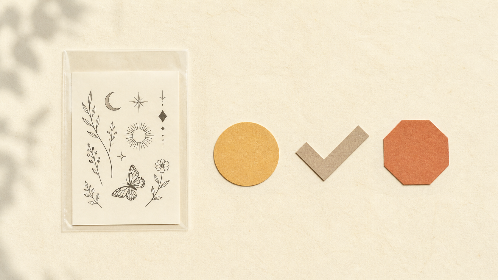 Unused temporary tattoo sheet beside simple check and stop shapes