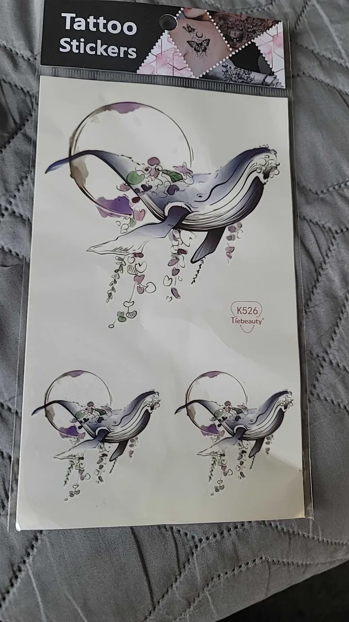 TikTok Shop customer photo of the K526 watercolor whale temporary tattoo sheet in its packaging